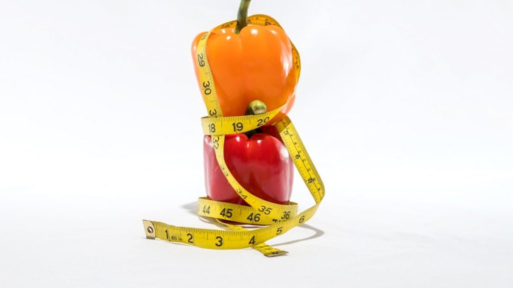 a measuring tape wrapped around a bell pepper
