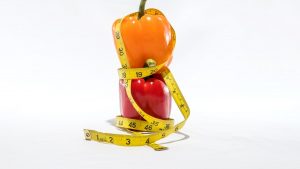 a measuring tape wrapped around a bell pepper